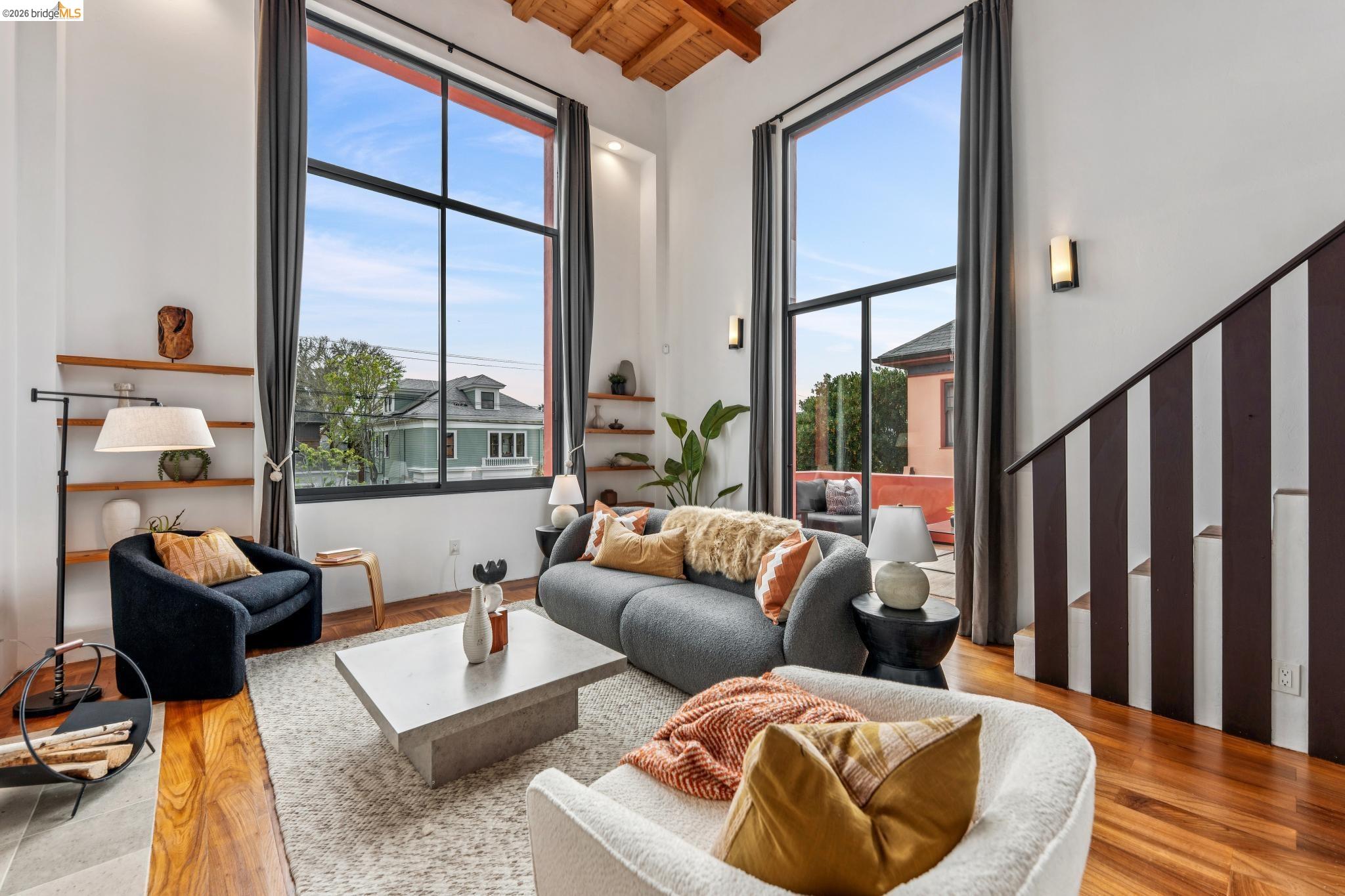 2015 Delaware Street, Unit A Berkeley, CA 94709 - Photo 27 of 60 a living room with furniture and a floor to ceiling window