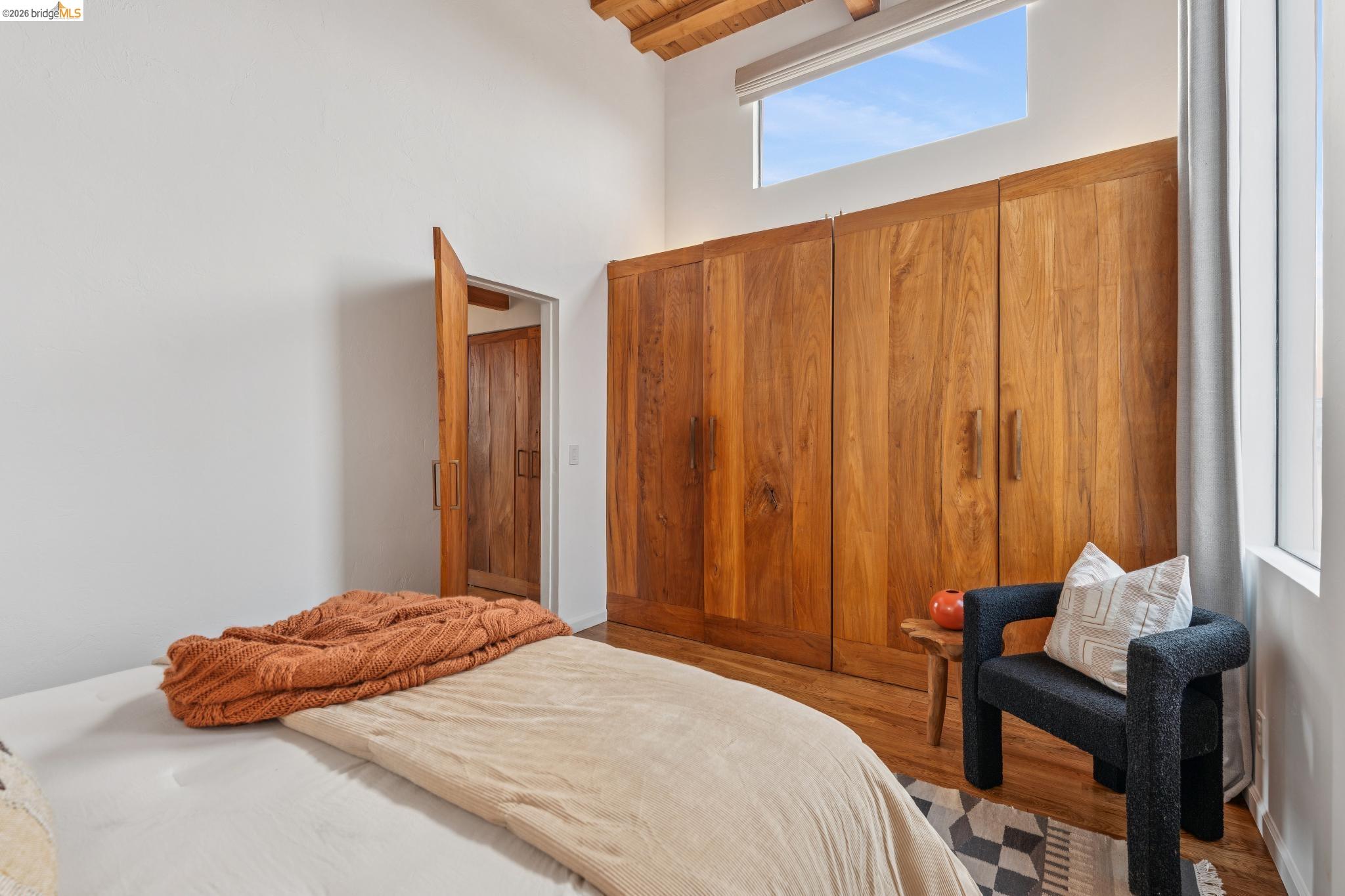 2015 Delaware Street, Unit A Berkeley, CA 94709 - Photo 40 of 60 a bedroom with a bed and a chair