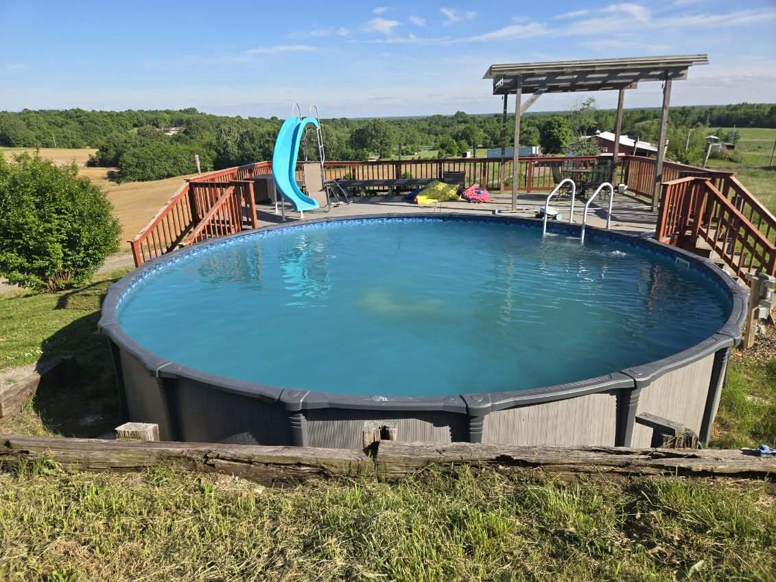 5488 Tick Ridge Road Grand Chain, IL 62941 - Photo 15 of 55 a view of a swimming pool with lawn chairs and plants