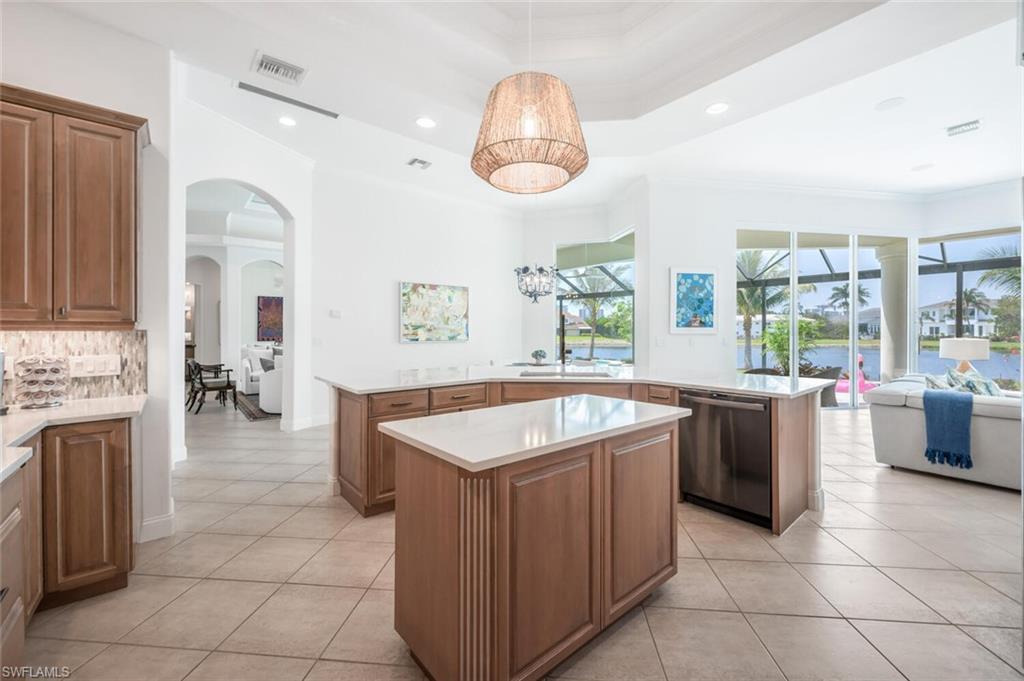 4129 Willowhead Way Naples, FL 34103 - Photo 12 of 50 a large kitchen with kitchen island a large counter space appliances and a window