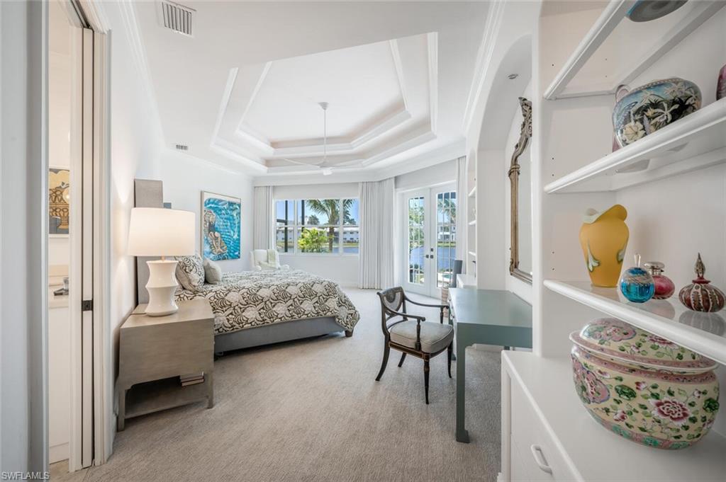 4129 Willowhead Way Naples, FL 34103 - Photo 20 of 50 a bedroom with furniture and a window