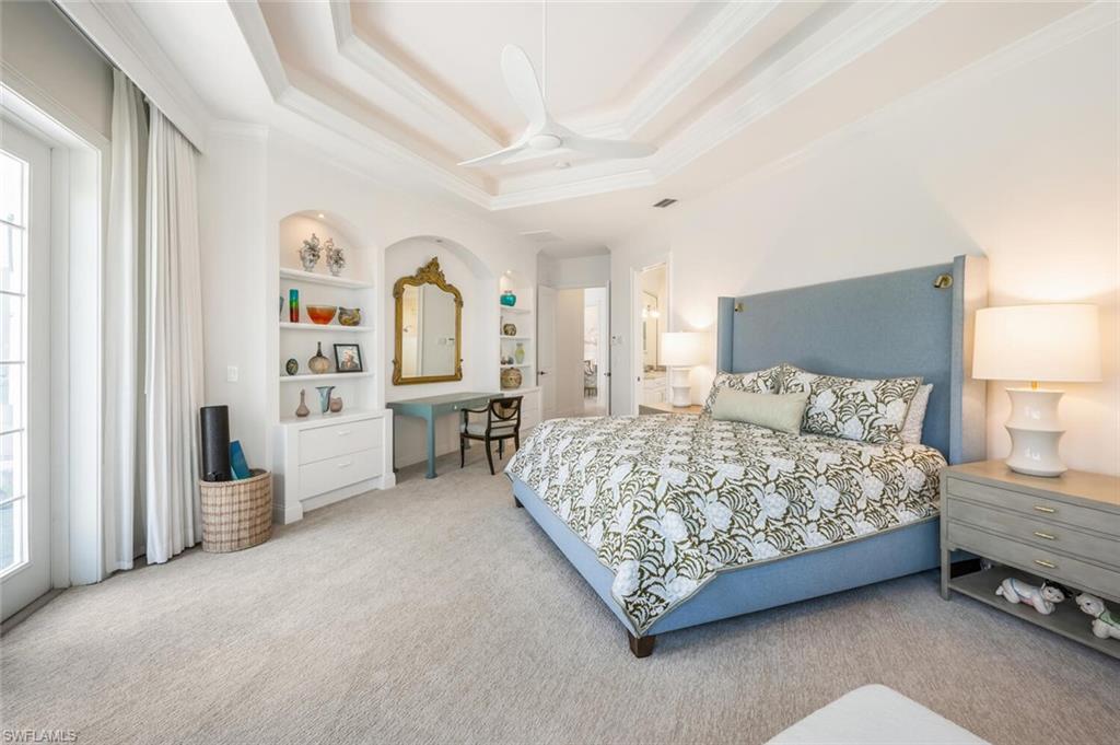 4129 Willowhead Way Naples, FL 34103 - Photo 21 of 50 a spacious bedroom with a bed and a cabinets