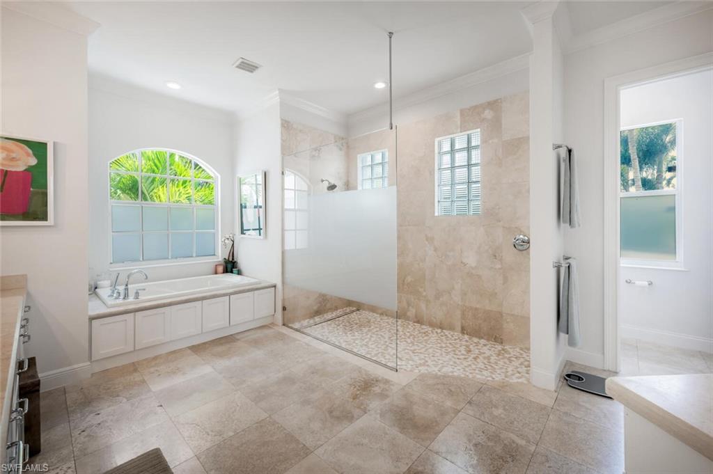 4129 Willowhead Way Naples, FL 34103 - Photo 22 of 50 a bathroom with a tub shower and mirror