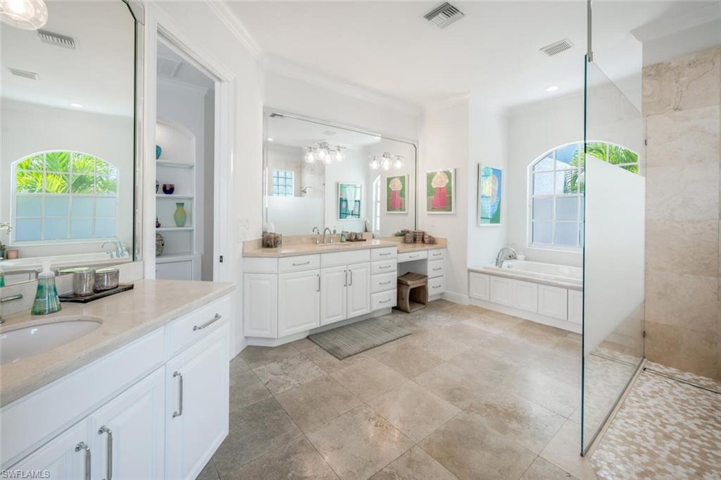 4129 Willowhead Way Naples, FL 34103 - Photo 23 of 50 a large white kitchen with a large window and stainless steel appliances