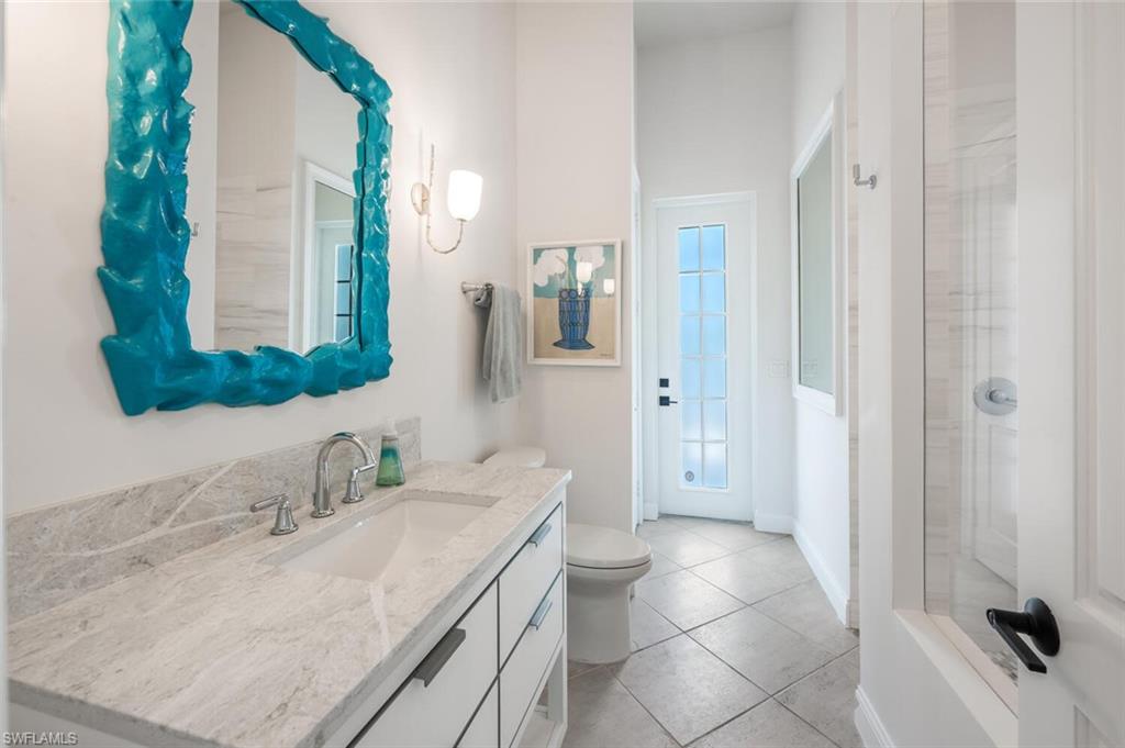 4129 Willowhead Way Naples, FL 34103 - Photo 25 of 50 a bathroom with a sink and a mirror