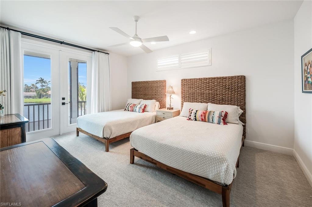 4129 Willowhead Way Naples, FL 34103 - Photo 29 of 50 a spacious bedroom with two beds and painted walls