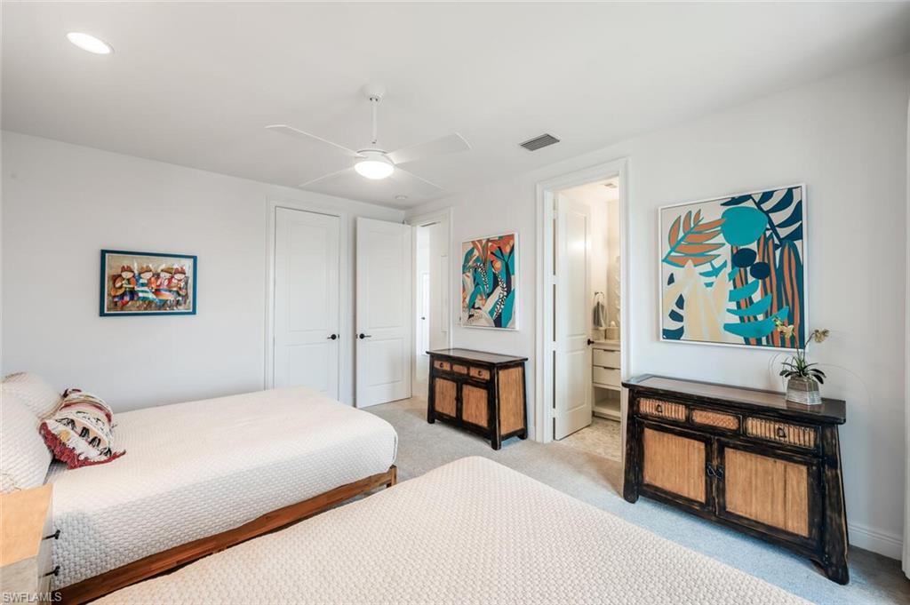 4129 Willowhead Way Naples, FL 34103 - Photo 30 of 50 a bedroom with a bed and furniture