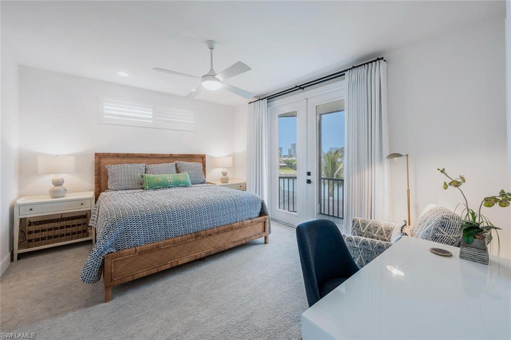4129 Willowhead Way Naples, FL 34103 - Photo 32 of 50 a bedroom with a bed and potted plant with a large window