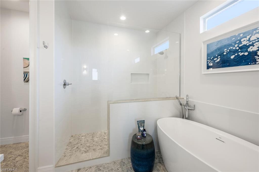 4129 Willowhead Way Naples, FL 34103 - Photo 34 of 50 a bathroom with a bathtub and shower