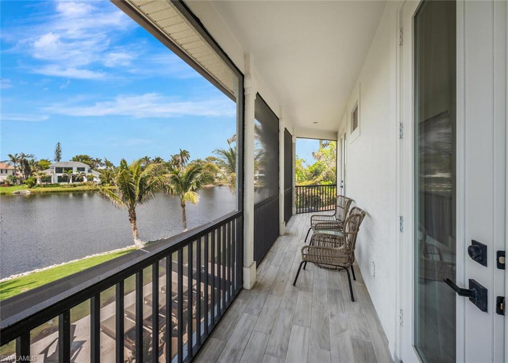 4129 Willowhead Way Naples, FL 34103 - Photo 36 of 50 a view of a balcony with wooden floor and lake view