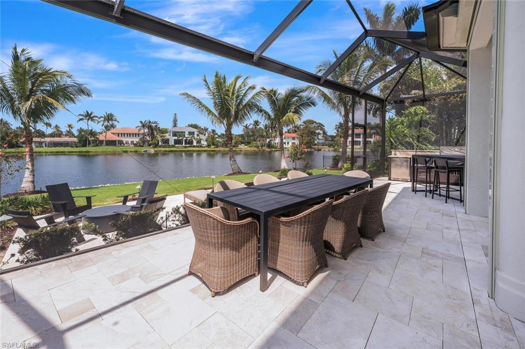 4129 Willowhead Way Naples, FL 34103 - Photo 46 of 50 a view of a patio with swimming pool table and chairs