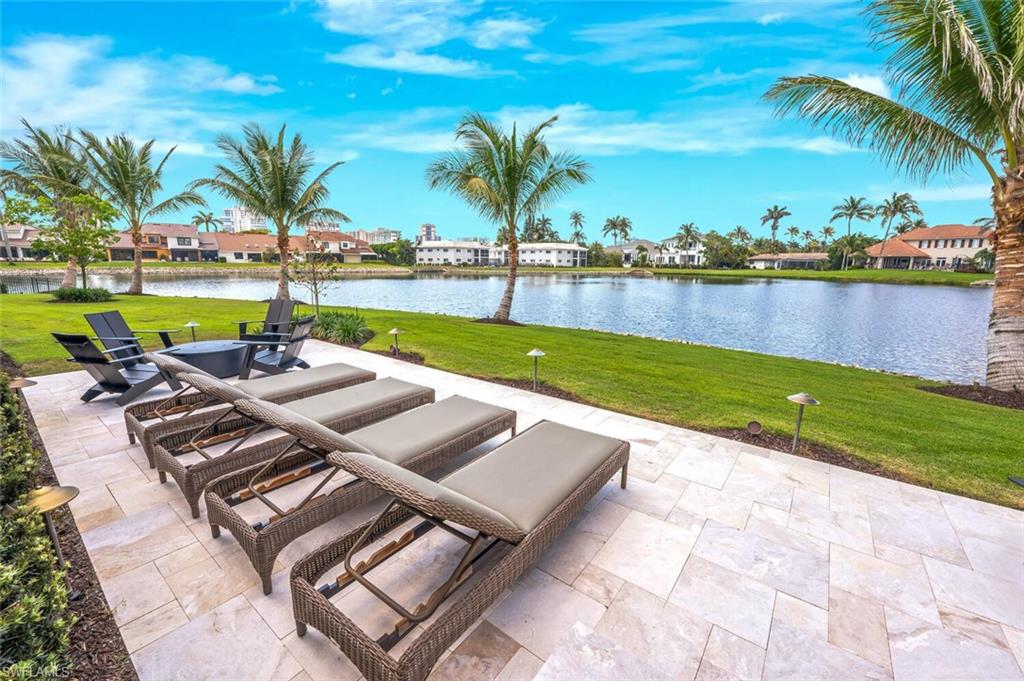4129 Willowhead Way Naples, FL 34103 - Photo 49 of 50 a view of a swimming pool and lounge chairs