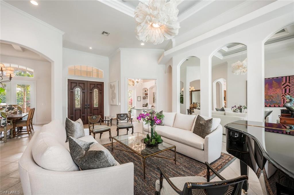 4129 Willowhead Way Naples, FL 34103 - Photo 5 of 50 a living room with furniture and a chandelier