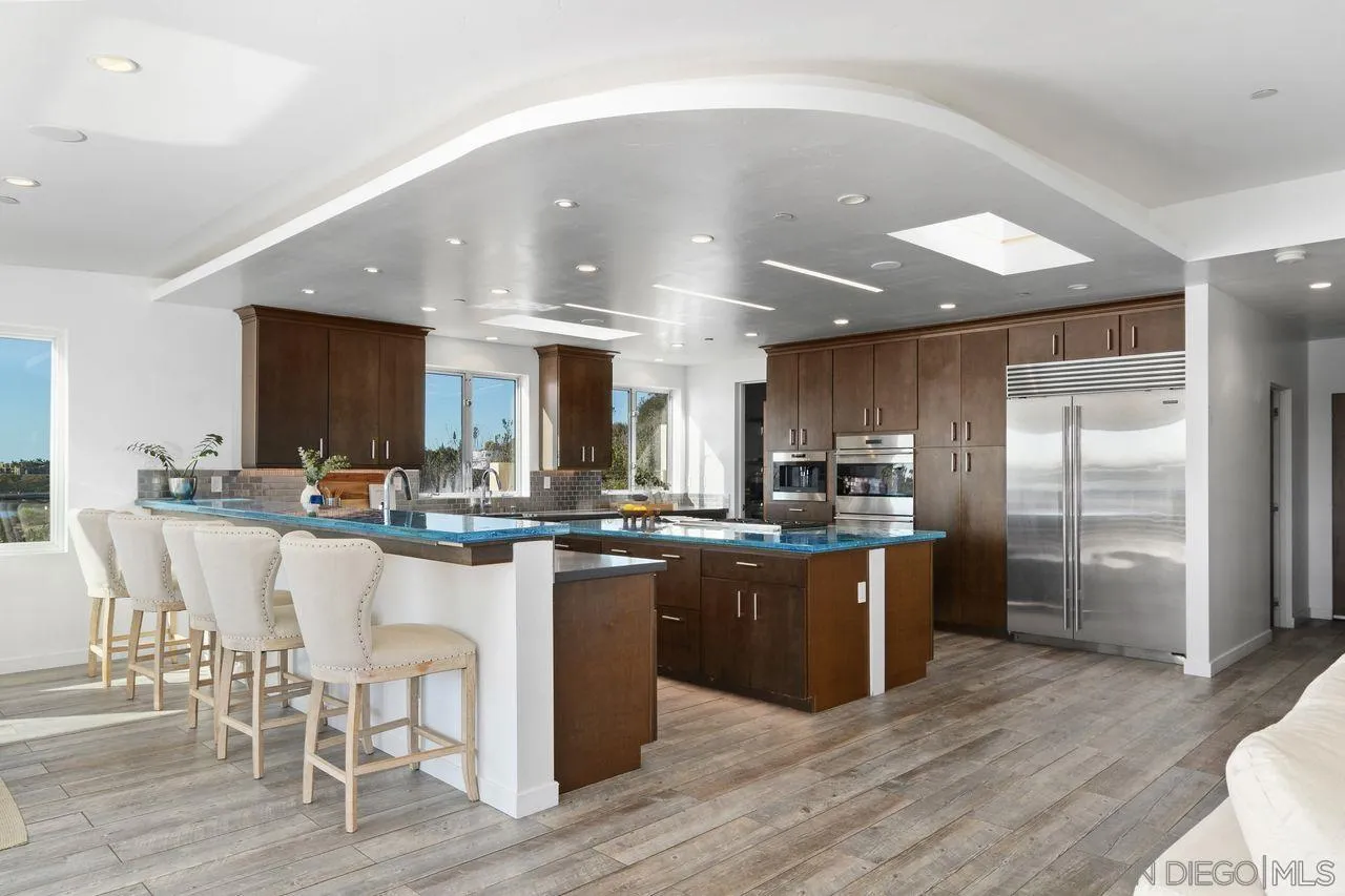 4465 Adams Street Carlsbad, CA 92008 - Photo 23 of 59 a kitchen with stainless steel appliances kitchen island granite countertop a stove and a refrigerator