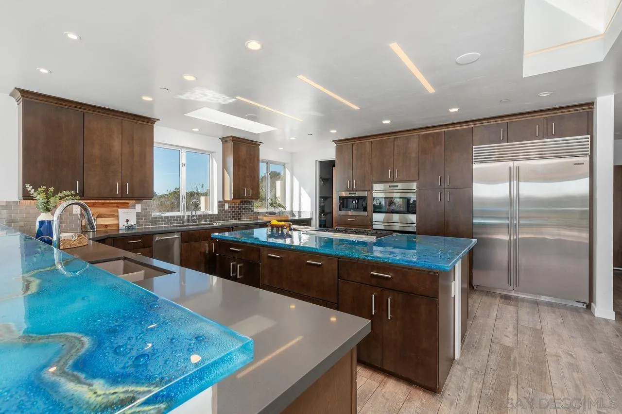 4465 Adams Street Carlsbad, CA 92008 - Photo 25 of 59 a kitchen with stainless steel appliances granite countertop a sink stove and refrigerator
