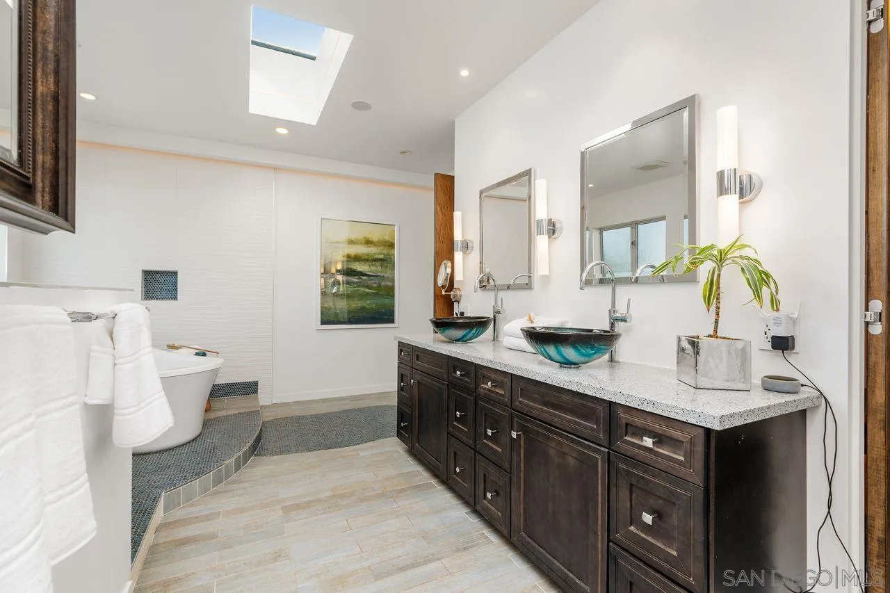 4465 Adams Street Carlsbad, CA 92008 - Photo 31 of 59 a spacious bathroom with a double vanity sink a mirror and a toilet