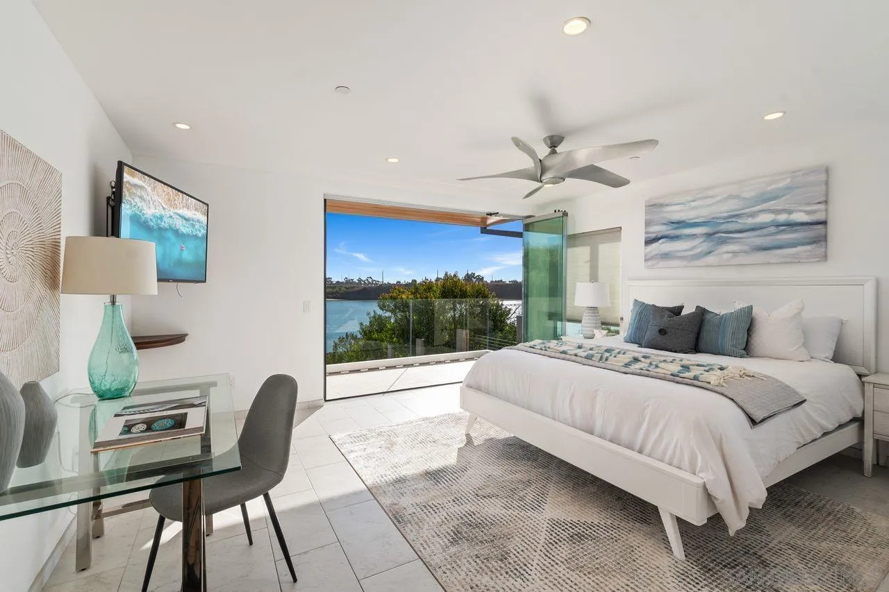 4465 Adams Street Carlsbad, CA 92008 - Photo 36 of 59 a bedroom with a bed a chair and potted plant with the outer view