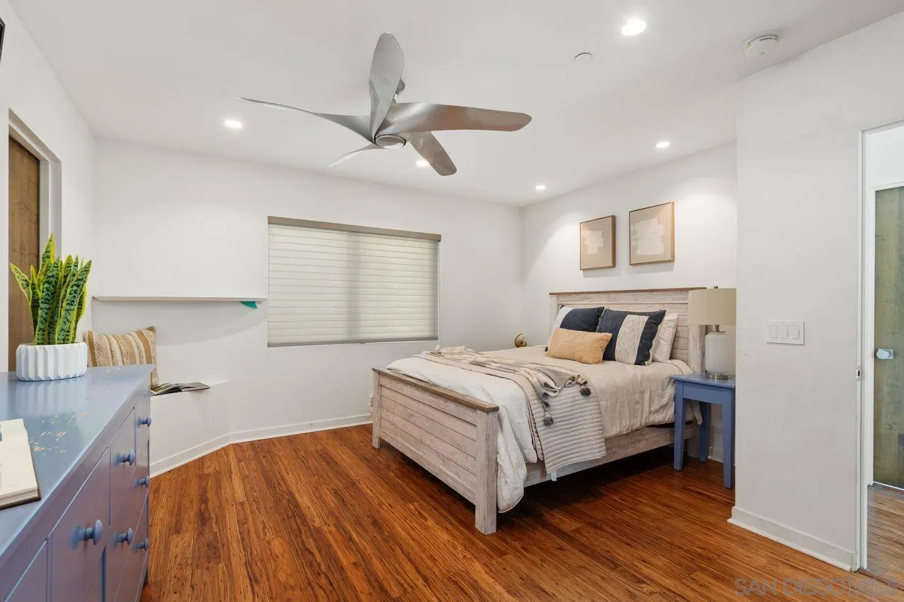 4465 Adams Street Carlsbad, CA 92008 - Photo 41 of 59 a bedroom with a bed and a chandelier