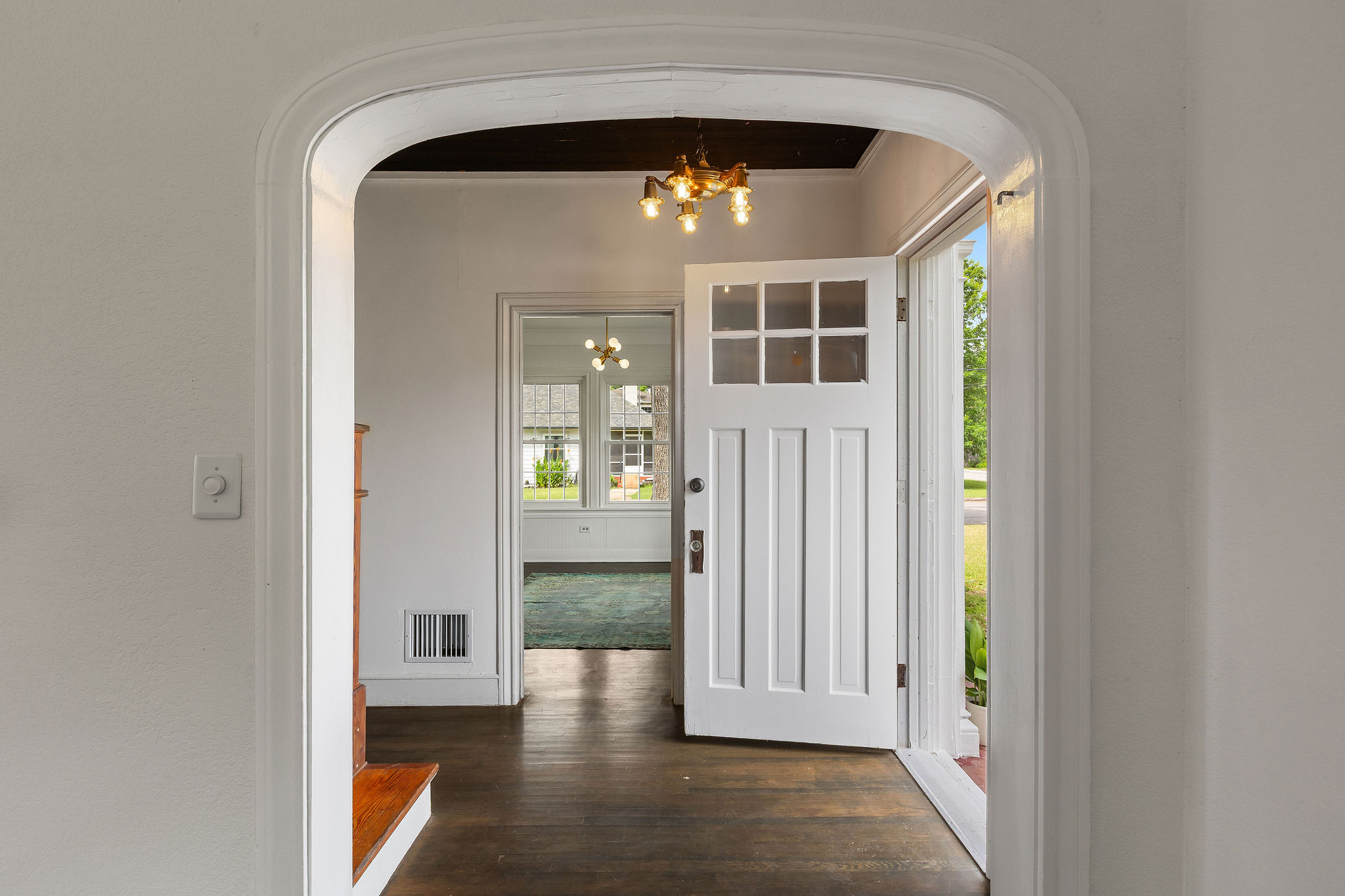 948 Maple Street Lockhart, TX 78644 - Photo 5 of 40 An inviting entry showcases classic hardwood flooring and a stylish decorative ceiling light fixture.