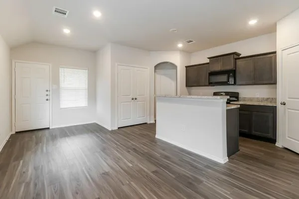 a kitchen with stainless steel appliances a refrigerator sink and microwave