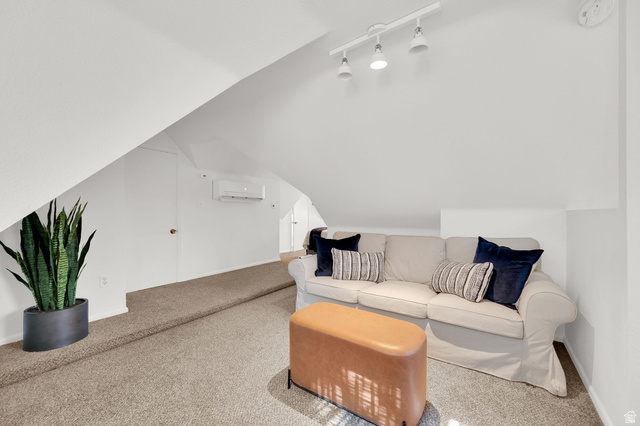 446 South 300 East Provo, UT 84606 - Photo 24 of 32 Carpeted loft space featuring sloped ceilings, track lighting, and a wall-mounted mini-split HVAC unit