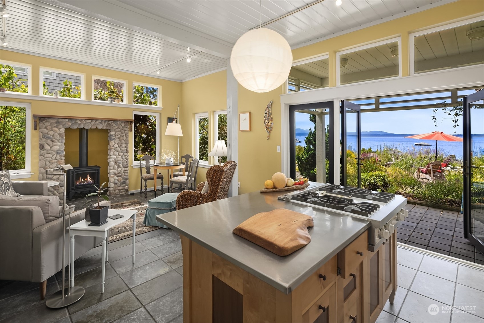 6346 South Bay Road Freeland, WA 98249 - Photo 14 of 40 a view of a dining room with furniture a chandelier and wooden floor