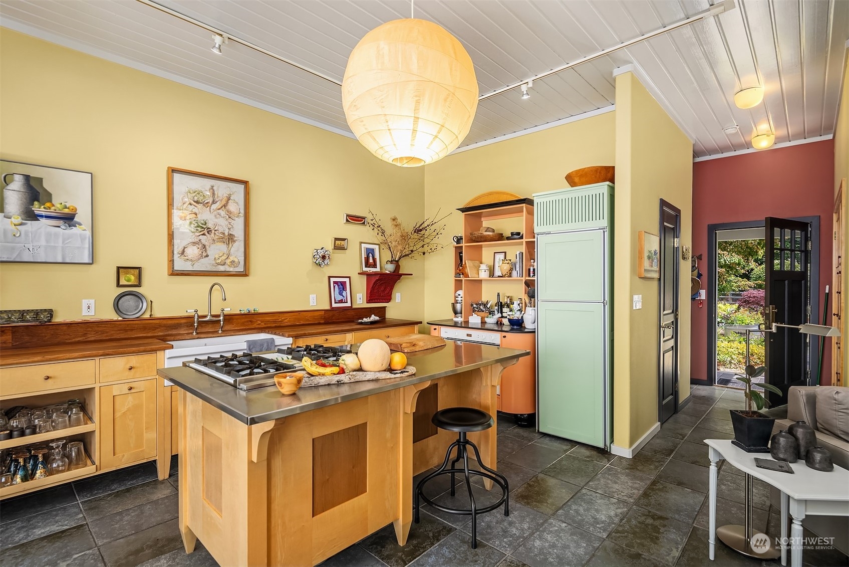 6346 South Bay Road Freeland, WA 98249 - Photo 21 of 40 a kitchen with stainless steel appliances granite countertop a stove a sink dishwasher and a dining table with garden view
