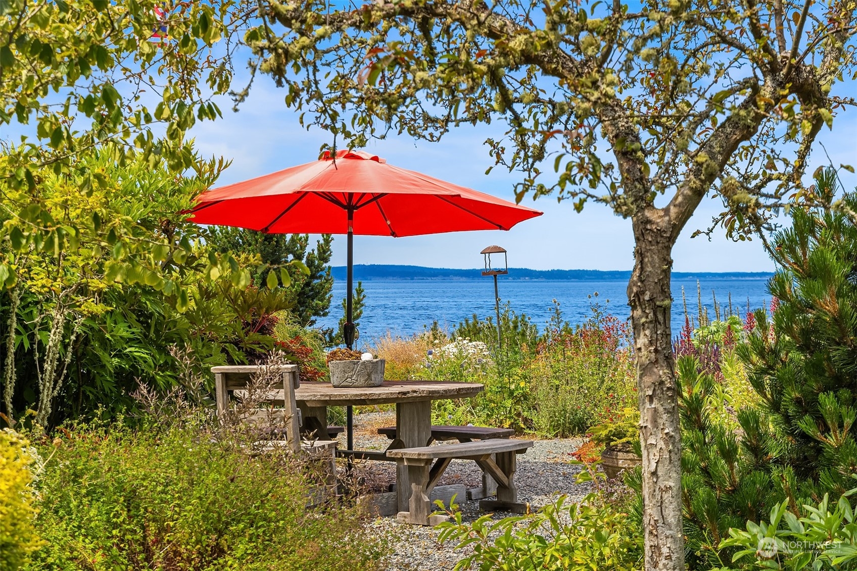 6346 South Bay Road Freeland, WA 98249 - Photo 33 of 40 a view of a patio with chairs under an umbrella
