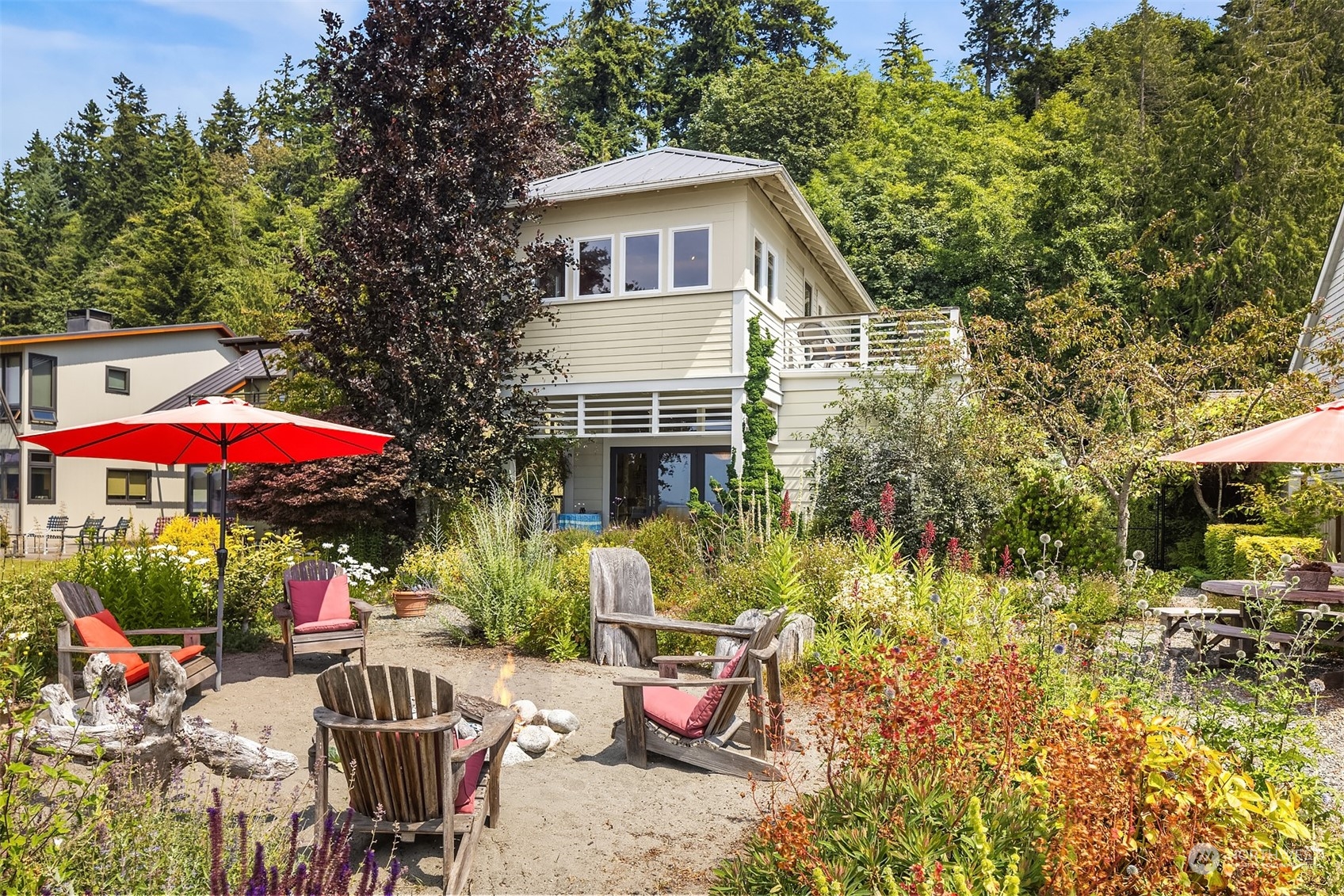 6346 South Bay Road Freeland, WA 98249 - Photo 9 of 40 a view of a patio with a table and chairs under an umbrella