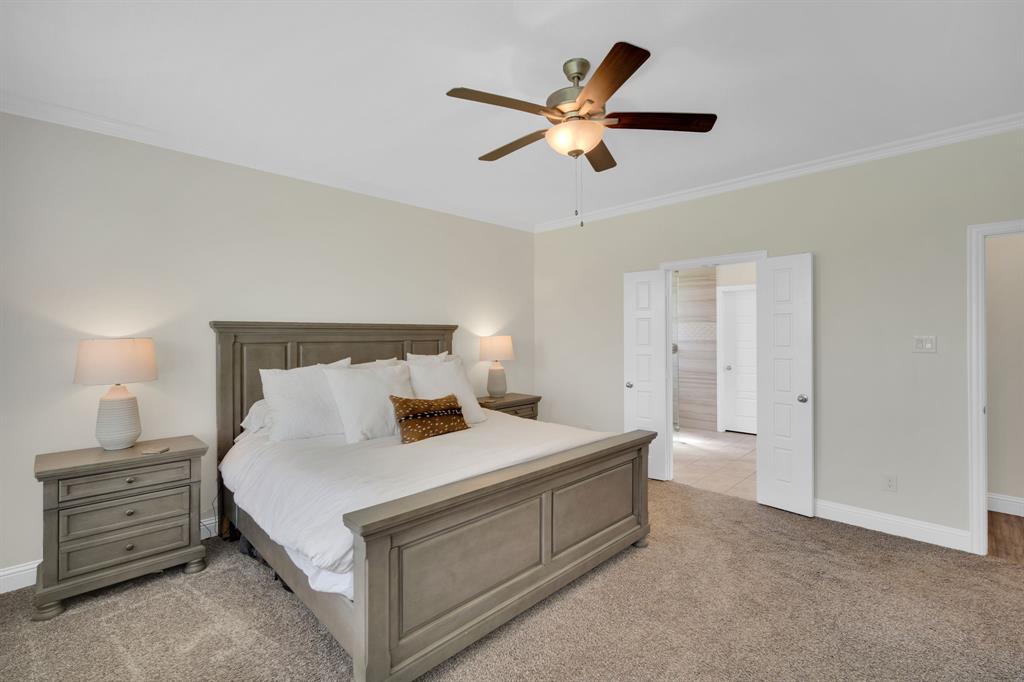 1601 Bear Path Way Gunter, TX 75058 - Photo 18 of 40 a bedroom with a bed and a chandelier