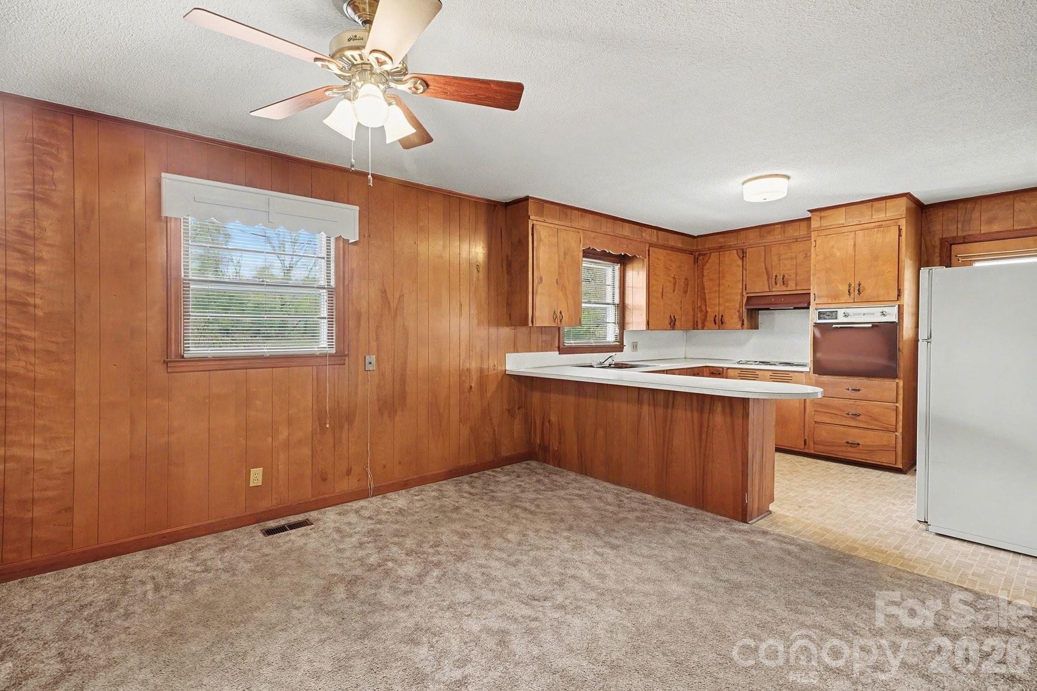 1612 Shelby Road, Unit 1417 Kings Mountain, NC 28086 - Photo 12 of 29 a kitchen with stainless steel appliances granite countertop a refrigerator a sink dishwasher a stove with wooden cabinets and floor