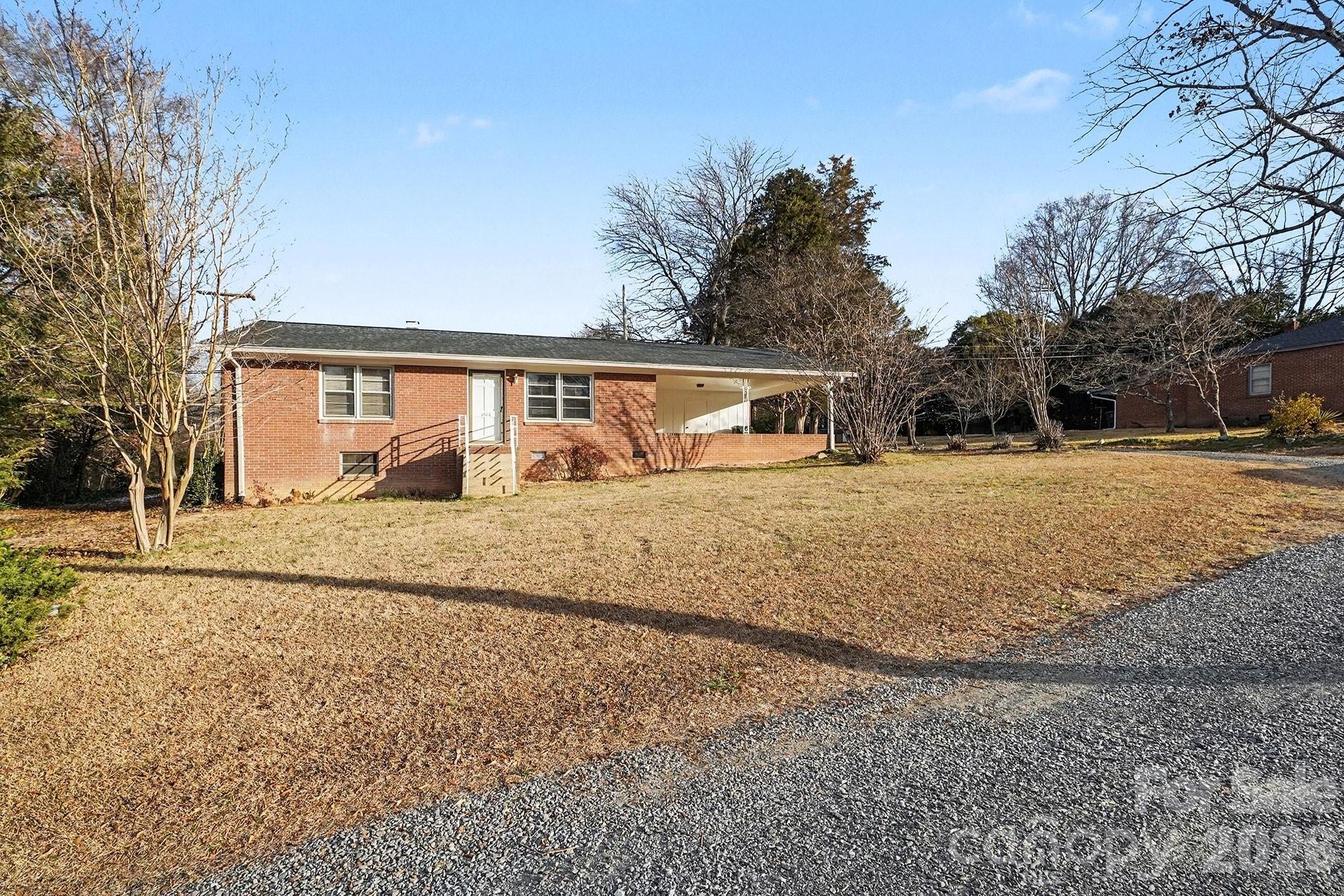 1612 Shelby Road, Unit 1417 Kings Mountain, NC 28086 - Photo 4 of 29 a front view of house with yard and trees around
