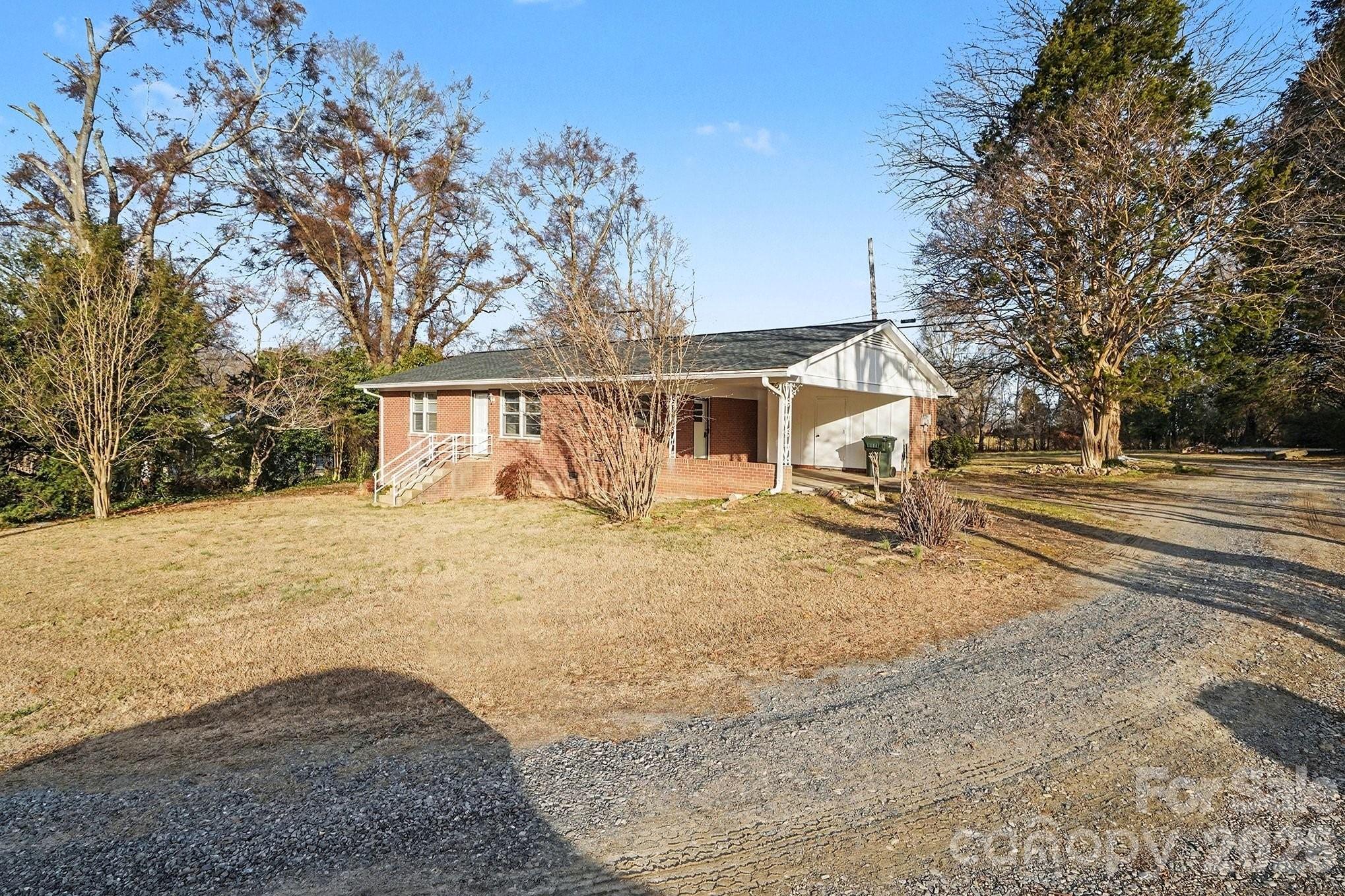 1612 Shelby Road, Unit 1417 Kings Mountain, NC 28086 - Photo 10 of 29 a front view of a house with a yard and garage