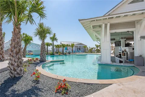 a view of a house with a backyard porch and sitting area