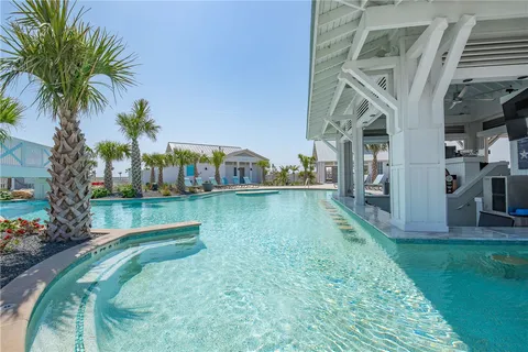 a view of a house with swimming pool and sitting area