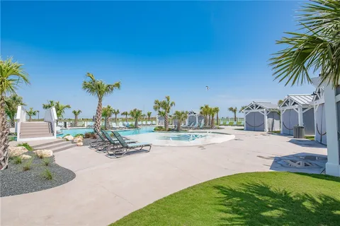 a swimming pool with outdoor seating and yard