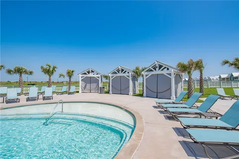 a view of a swimming pool with outdoor seating