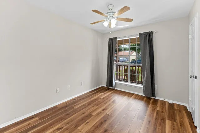 wooden floor in an empty room with a window