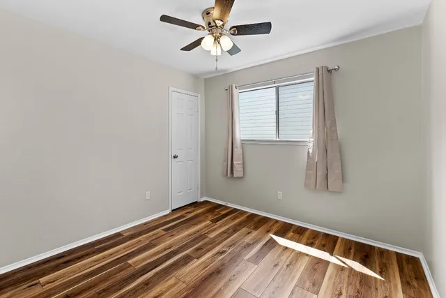 a view of room with window and ceiling fan