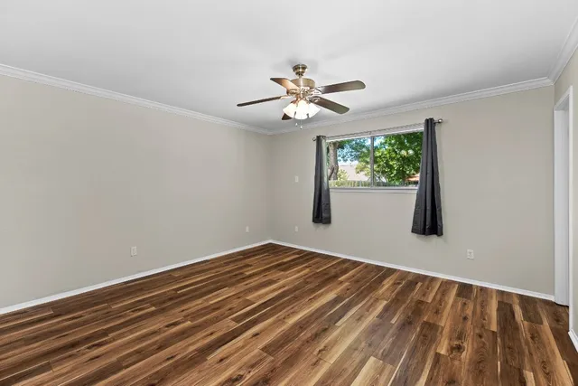 wooden floor in an empty room with a window