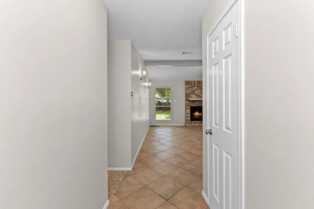 a view of a hallway with wooden shelves