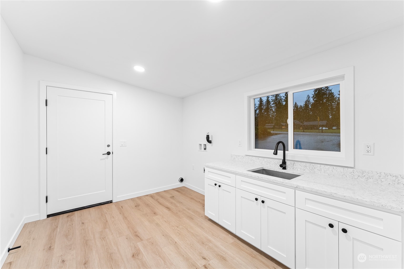 23033 192nd Avenue Southeast Renton, WA 98058 - Photo 29 of 40 a kitchen with a sink and cabinets
