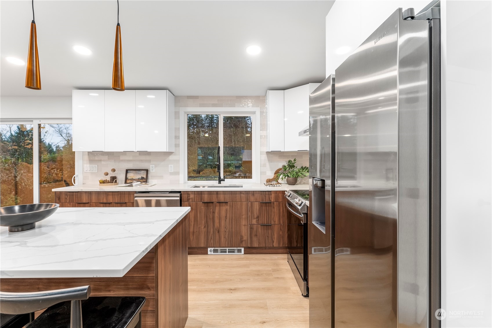 23033 192nd Avenue Southeast Renton, WA 98058 - Photo 32 of 40 a kitchen with kitchen island a counter top space a sink appliances and cabinets