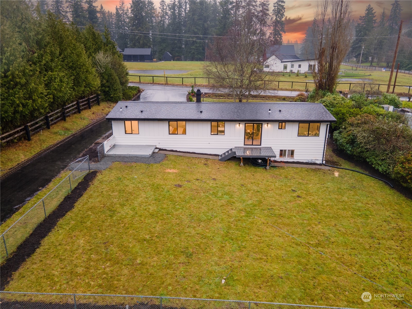 23033 192nd Avenue Southeast Renton, WA 98058 - Photo 36 of 40 a view of a large pool with lawn chairs under an umbrella