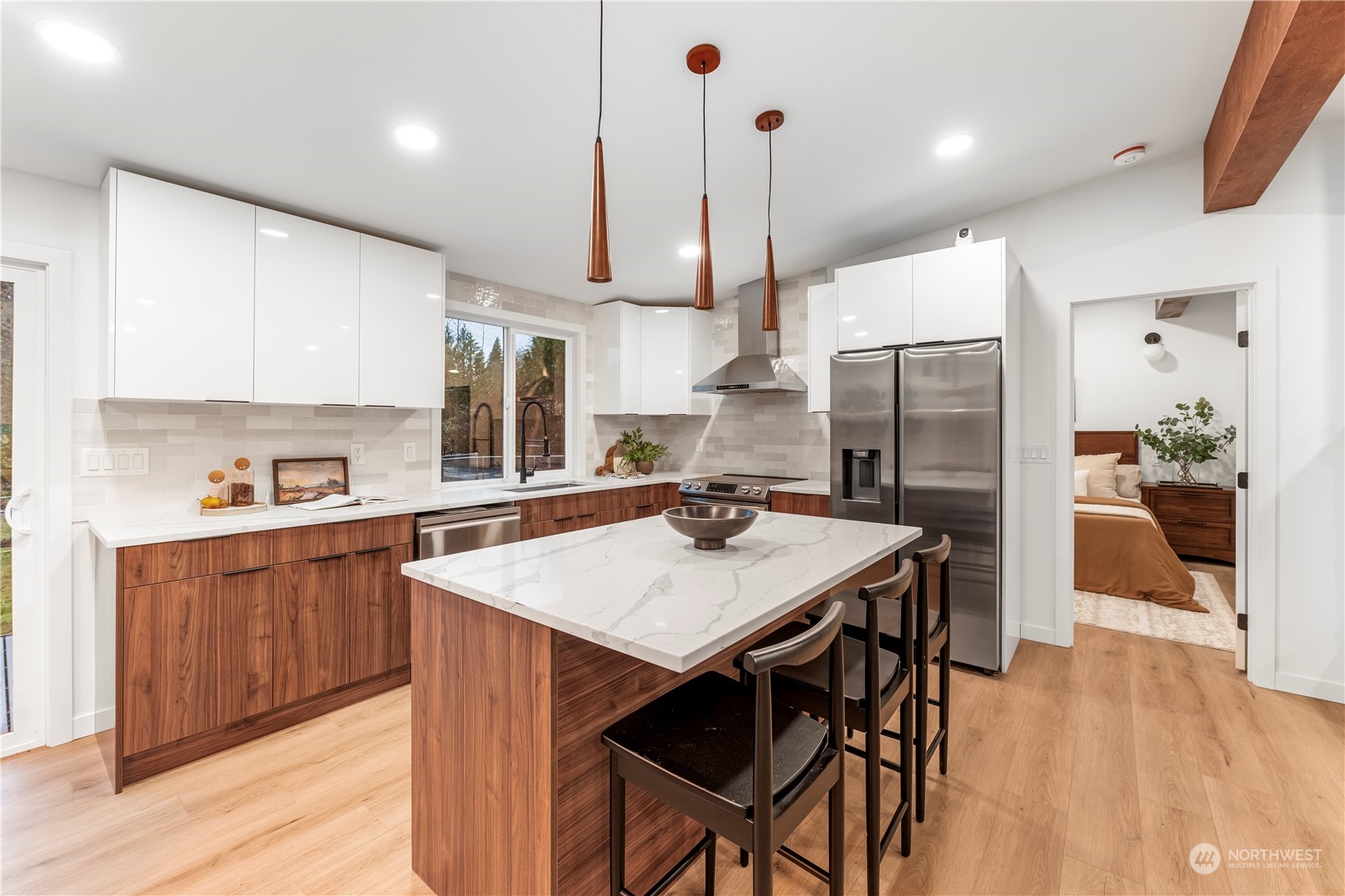 23033 192nd Avenue Southeast Renton, WA 98058 - Photo 9 of 40 a kitchen with stainless steel appliances kitchen island a table and chairs in it