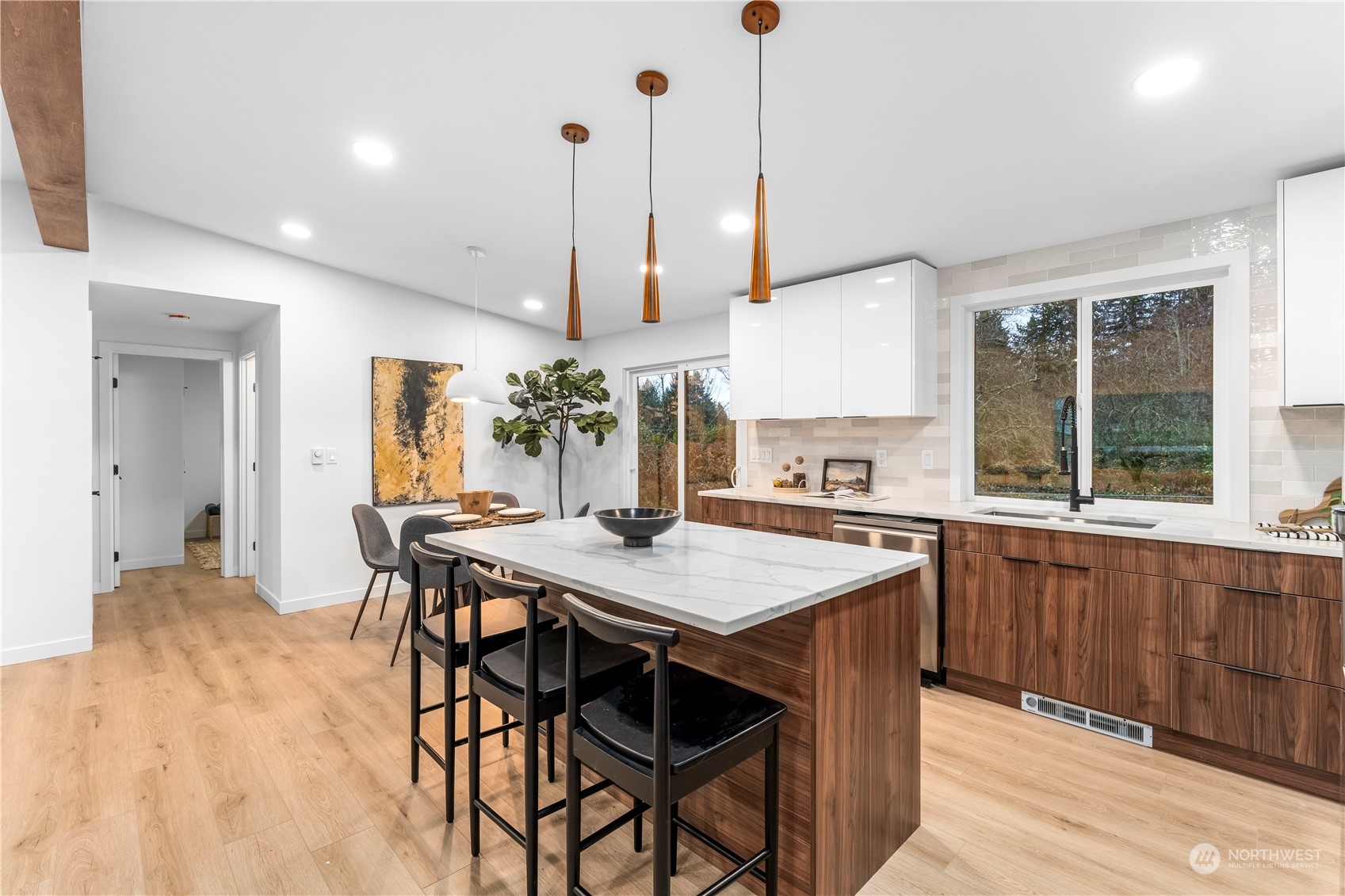 23033 192nd Avenue Southeast Renton, WA 98058 - Photo 10 of 40 a view of a kitchen with kitchen island dining table and chairs