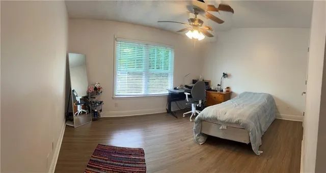 a bedroom with furniture and a window