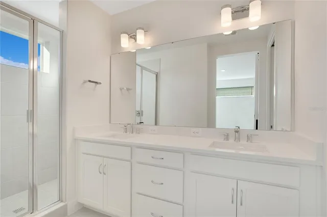 a bathroom with a sink double vanity and a mirror