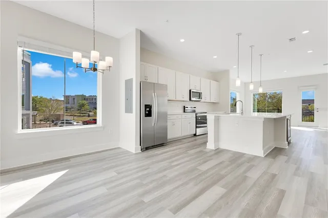 a view of a kitchen center island wooden floor and a window