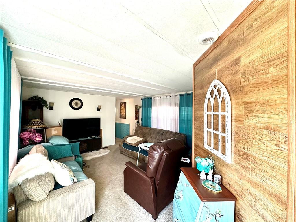 412 Richmond Road Imperial, PA 15126 - Photo 4 of 12 a living room with furniture a fireplace and a flat screen tv